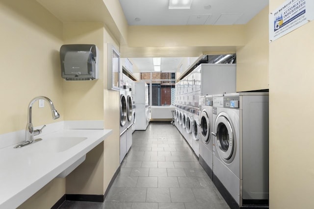 189 Schermerhorn St Unit 16C, New York City, NY 11201 - shared laundry room featuring stacked washer / drying machine, washer and clothes dryer, baseboards, and dark tile patterned flooring