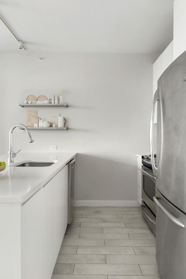 189 Schermerhorn St Unit 16C, New York City, NY 11201 - kitchen with stainless steel appliances, a sink, white cabinets, and modern cabinets