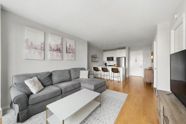 189 Schermerhorn St Unit 16C, New York City, NY 11201 - living room featuring light wood finished floors and rail lighting