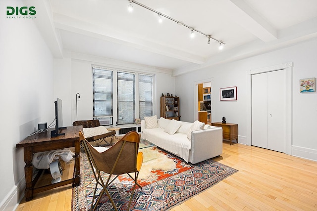 135 W 79th St Unit 1D, New York City, NY 10024 - living area featuring track lighting, light wood finished floors, and beam ceiling
