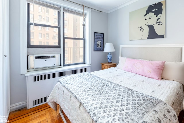 300 W 72nd St Unit 6E, New York City, NY 10023 - bedroom with radiator, multiple windows, crown molding, baseboards, and cooling unit