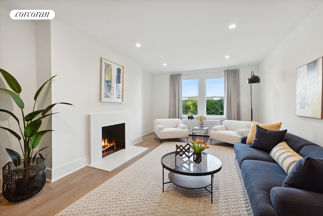 148-09 Northern Blvd Unit 4M, New York City, NY 11354 - living room with wood finished floors, a warm lit fireplace, recessed lighting, and baseboards