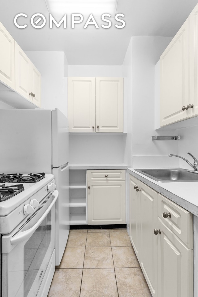 101 W 12th St Unit 3Z, New York City, NY 10011 - kitchen with white range with gas cooktop, light countertops, and white cabinets