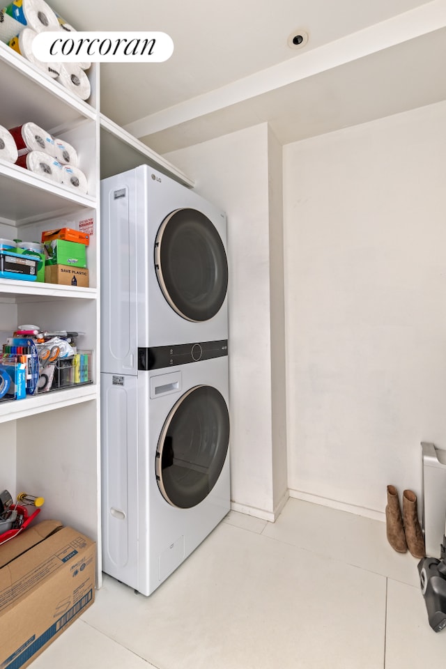 145 6th Ave Unit 5C, New York City, NY 10013 - laundry room featuring estacked washer and dryer and tile patterned floors