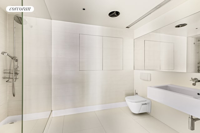 145 6th Ave Unit 5C, New York City, NY 10013 - bathroom featuring toilet, tiled shower, tile patterned flooring, and a sink
