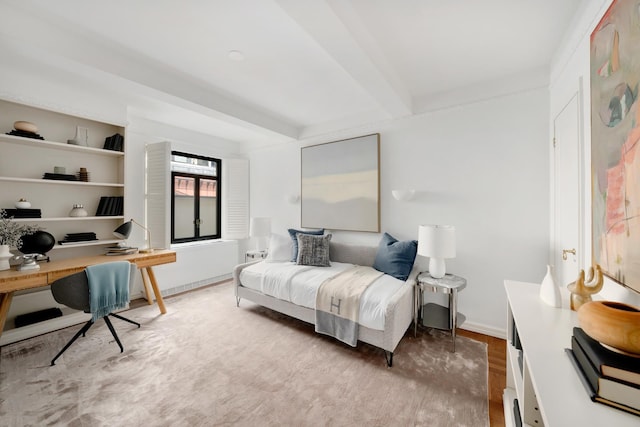 25 W 54th St Unit 8H, New York City, NY 10019 - bedroom featuring beamed ceiling, a desk, wood finished floors, and baseboards