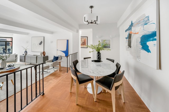 25 W 54th St Unit 8H, New York City, NY 10019 - dining room featuring a chandelier and baseboards