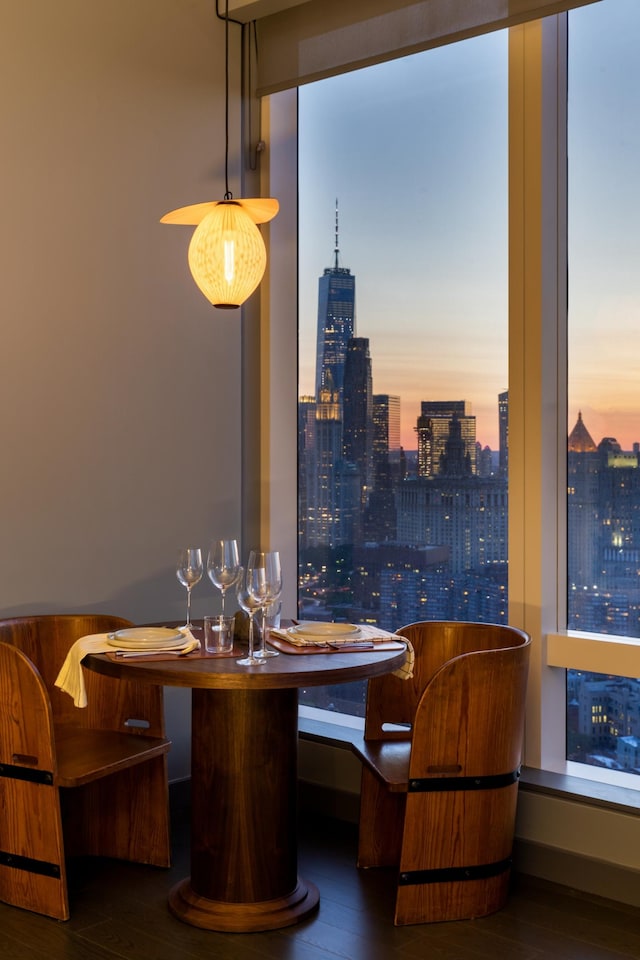 252 S St Unit 27L, New York City, NY 10002 - dining space with wood finished floors, a skyline view, and bar area