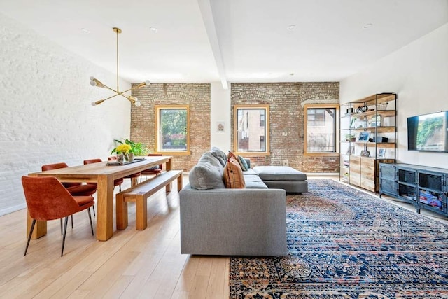 204 W Houston St Unit 4A/5A, New York City, NY 10014 - living room with brick wall, wood finished floors, and beamed ceiling
