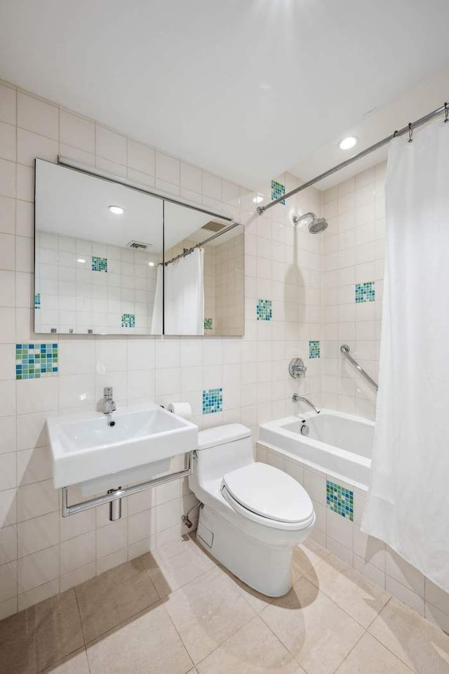 204 W Houston St Unit 4A/5A, New York City, NY 10014 - full bathroom featuring tile walls, tiled shower / bath combo, tile patterned floors, toilet, and backsplash