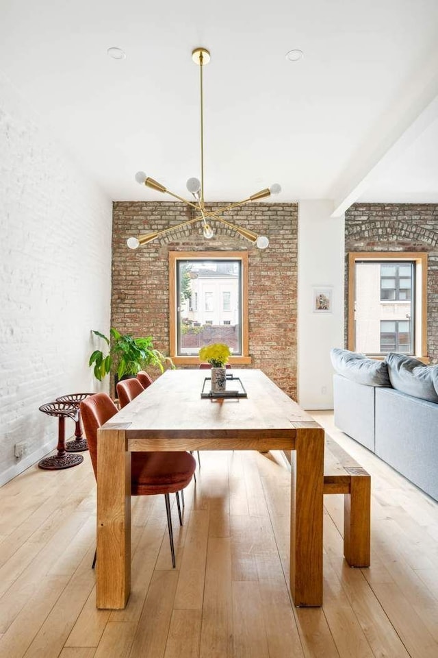 204 W Houston St Unit 4A/5A, New York City, NY 10014 - dining space featuring brick wall and light wood-style floors
