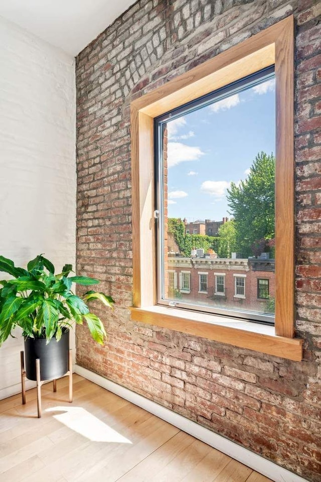 204 W Houston St Unit 4A/5A, New York City, NY 10014 - detailed view of brick wall, wood finished floors, and baseboards