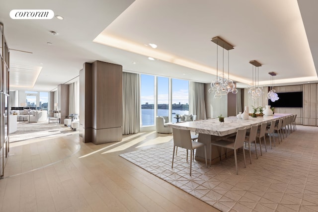 30 Riverside Blvd Unit 20C, New York City, NY 10069 - dining area featuring a raised ceiling, a wall of windows, light wood-style flooring, a chandelier, and recessed lighting