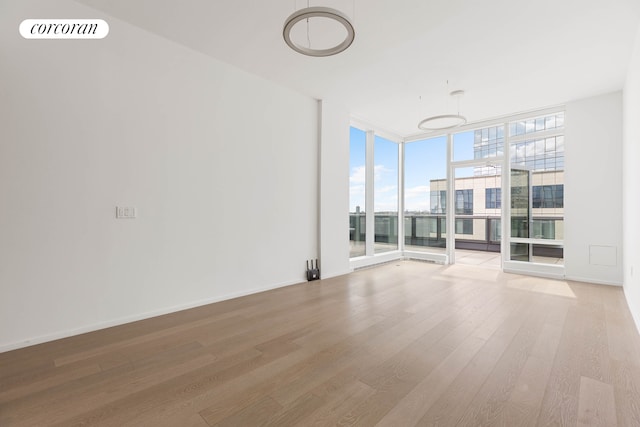 30 Riverside Blvd Unit 20C, New York City, NY 10069 - unfurnished room with expansive windows, light wood-type flooring, and baseboards