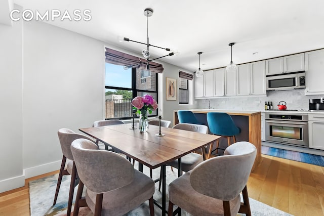 185 Prospect Park SW Unit 609, New York City, NY 11218 - dining room with light wood-type flooring and baseboards