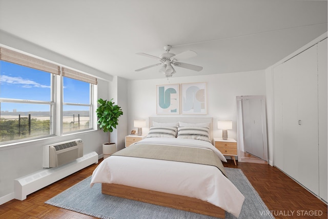 5900 Arlington Ave Unit 10H, New York City, NY 10471 - bedroom with a baseboard heating unit, a wall mounted AC, a ceiling fan, and baseboards