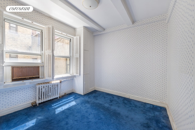 114 E 90th St Unit 5B, New York City, NY 10128 - spare room with radiator heating unit, wallpapered walls, beamed ceiling, and carpet floors