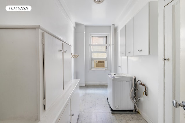 114 E 90th St Unit 5B, New York City, NY 10128 - laundry room with cabinet space, cooling unit, radiator, and light flooring