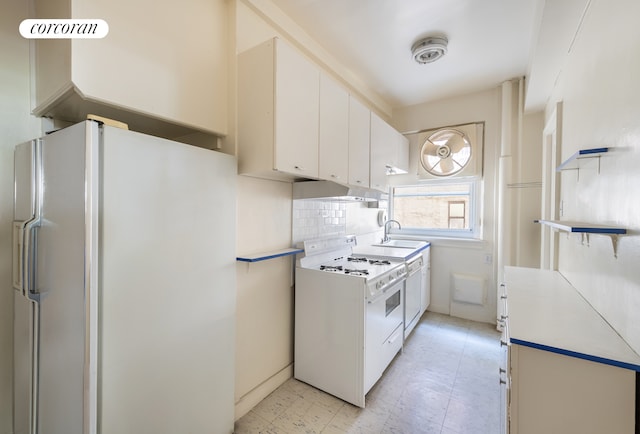 114 E 90th St Unit 5B, New York City, NY 10128 - kitchen featuring white appliances, light countertops, white cabinets, decorative backsplash, and light flooring