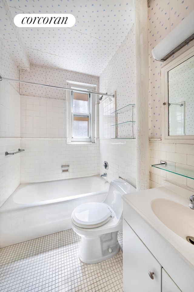 114 E 90th St Unit 5B, New York City, NY 10128 - bathroom featuring vanity, washtub / shower combination, wallpapered walls, tile walls, and tile patterned flooring