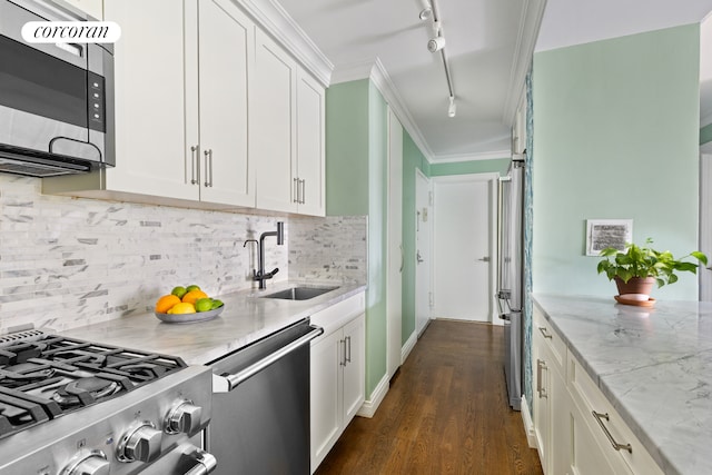 625 Main St Unit 643, New York City, NY 10044 - kitchen with stainless steel appliances, rail lighting, light stone countertops, white cabinets, and dark wood finished floors