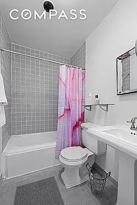 604 Riverside Dr Unit 4E, New York City, NY 10031 - bathroom featuring tile patterned flooring and shower / tub combo with curtain