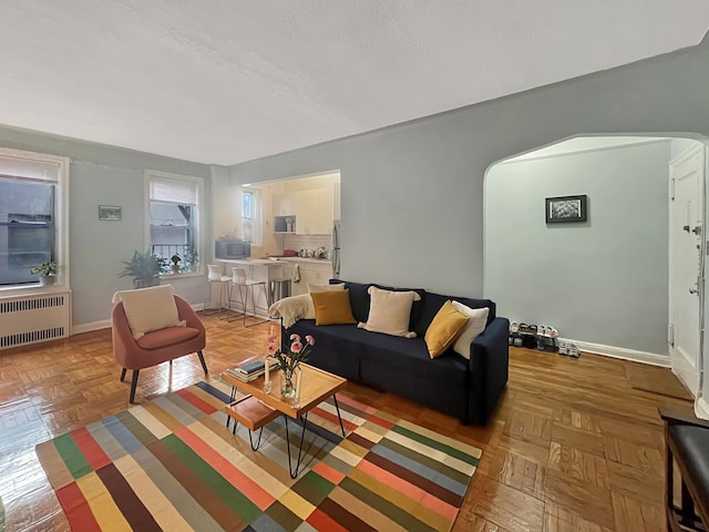 81 Ocean Pkwy Unit 5-P, New York City, NY 11218 - living area with radiator, arched walkways, and baseboards