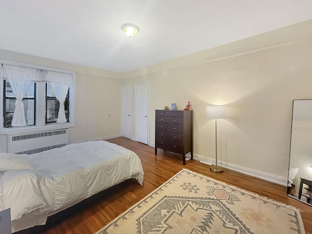 81 Ocean Pkwy Unit 5-P, New York City, NY 11218 - bedroom featuring radiator, wood finished floors, and baseboards