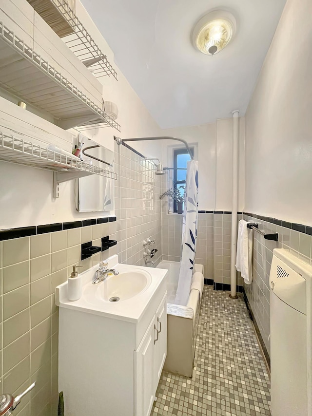 81 Ocean Pkwy Unit 5-P, New York City, NY 11218 - bathroom featuring tile walls, vanity, shower / tub combo with curtain, tile patterned flooring, and wainscoting
