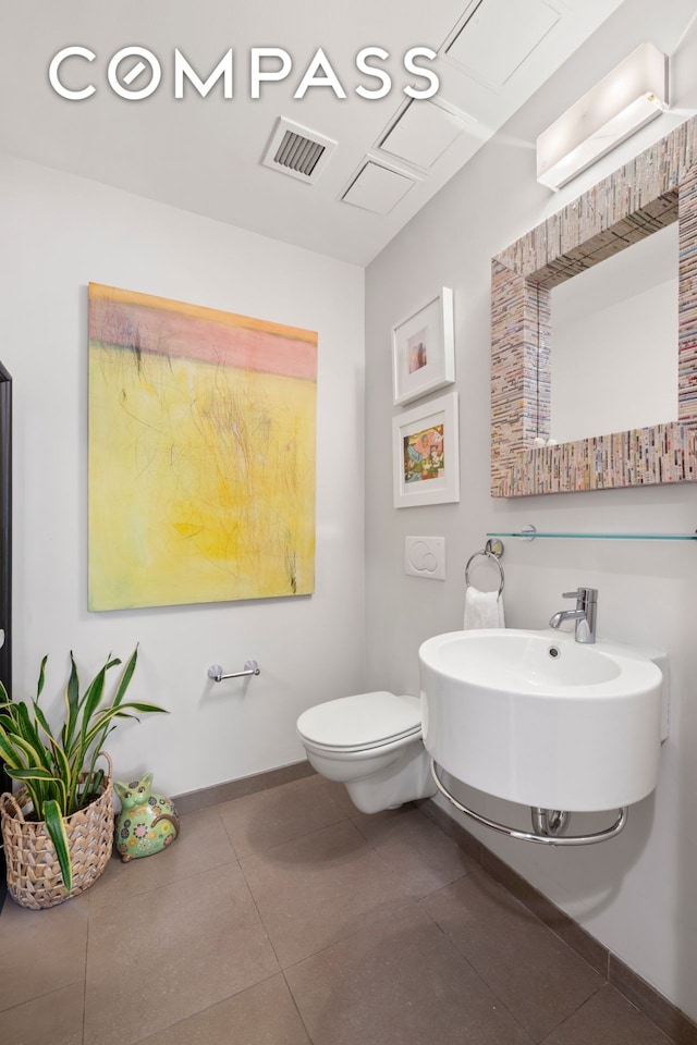 50 W 15th St Unit 2D, New York City, NY 10011 - half bath with toilet, baseboards, and tile patterned floors