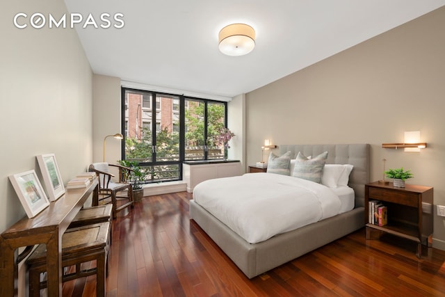50 W 15th St Unit 2D, New York City, NY 10011 - bedroom with dark wood-style floors and expansive windows