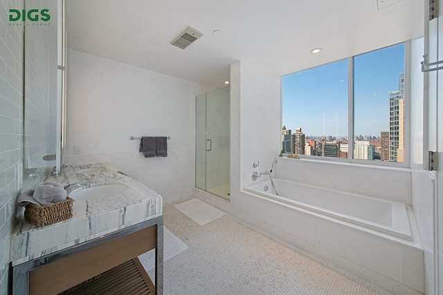 389 E 89th St Unit 27A, New York City, NY 10128 - bathroom featuring a garden tub, a view of city, a shower stall, and double vanity