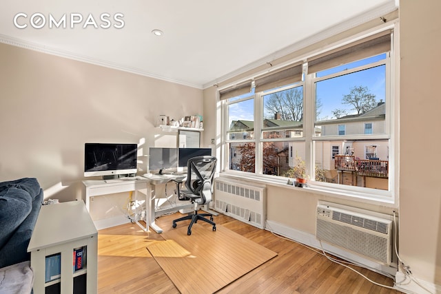 5730 Mosholu Ave Unit 4Ff, New York City, NY 10471 - office area featuring radiator heating unit, crown molding, baseboards, wood finished floors, and a wall unit AC
