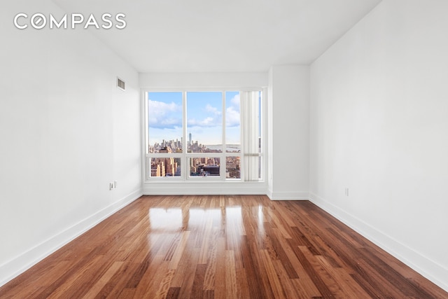 350 W 42nd St Unit 48E, New York City, NY 10036 - unfurnished room with baseboards and wood finished floors