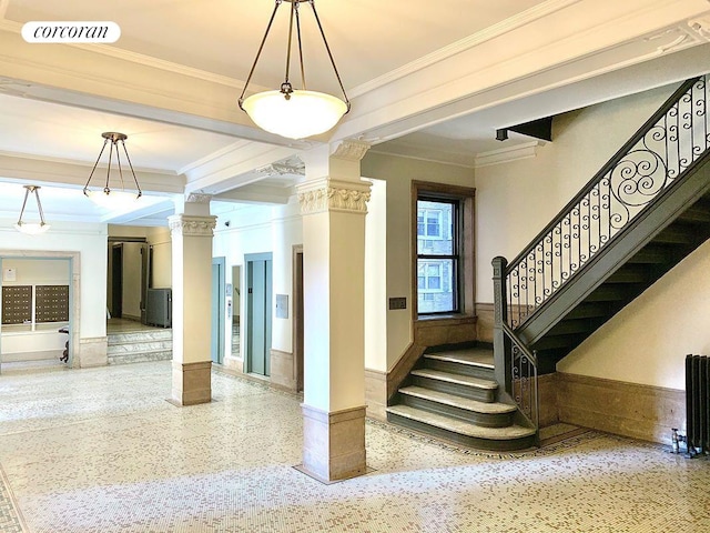 875 W 181st St Unit 6B, New York City, NY 10033 - stairway featuring speckle patterned floor, decorative columns, crown molding, elevator, and baseboards