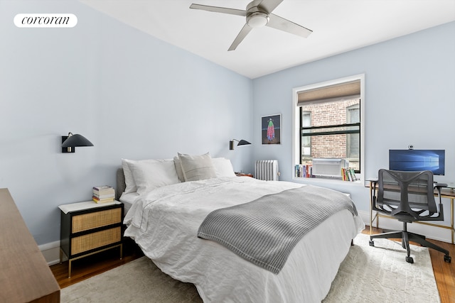 875 W 181st St Unit 6B, New York City, NY 10033 - bedroom featuring radiator heating unit, wood finished floors, baseboards, an office area, and cooling unit