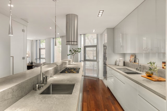 9 Minetta St, New York City, NY 10012 - kitchen with a sink, white cabinetry, dark wood finished floors, a wall of windows, and modern cabinets