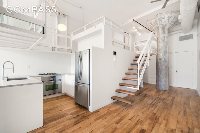 689 Myrtle Ave Unit 4E, New York City, NY 11205 - kitchen featuring freestanding refrigerator, oven, light wood-type flooring, white cabinets, and open shelves