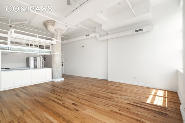689 Myrtle Ave Unit 4E, New York City, NY 11205 - unfurnished living room with light wood finished floors and baseboards