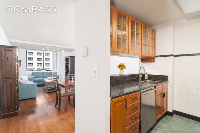 275 W 96th St Unit 12B, New York City, NY 10025 - kitchen featuring dishwasher, a sink, glass insert cabinets, dark stone counters, and open floor plan