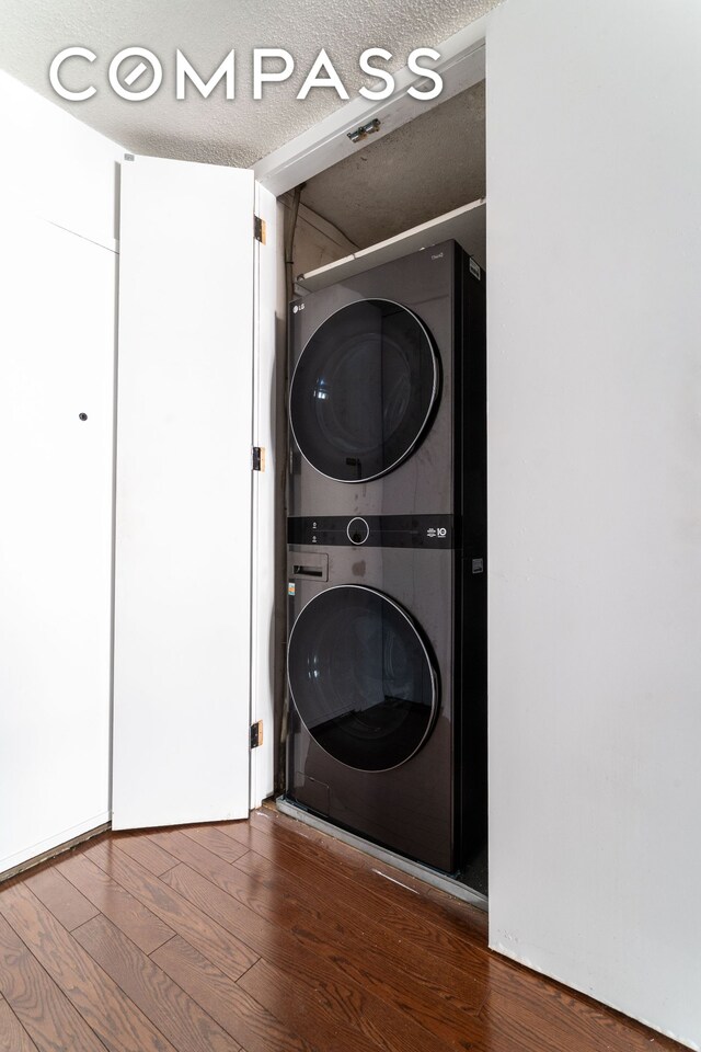 275 W 96th St Unit 12B, New York City, NY 10025 - washroom with stacked washing machine and dryer and wood finished floors