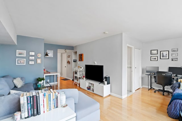 225 E 36th St Unit 15-A, New York City, NY 10016 - living room with light wood-style floors, an office area, and baseboards