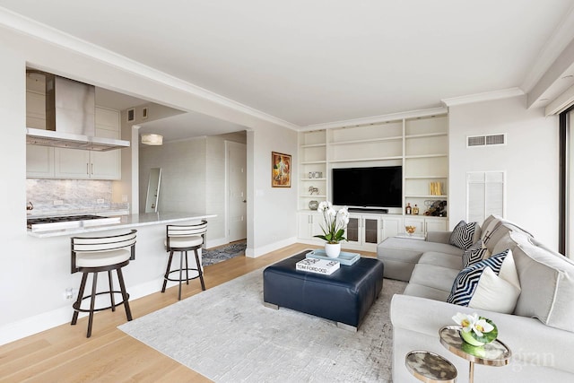 200 E 69th St Unit 28B, New York City, NY 10021 - living area featuring light wood-style flooring, crown molding, baseboards, and built in shelves