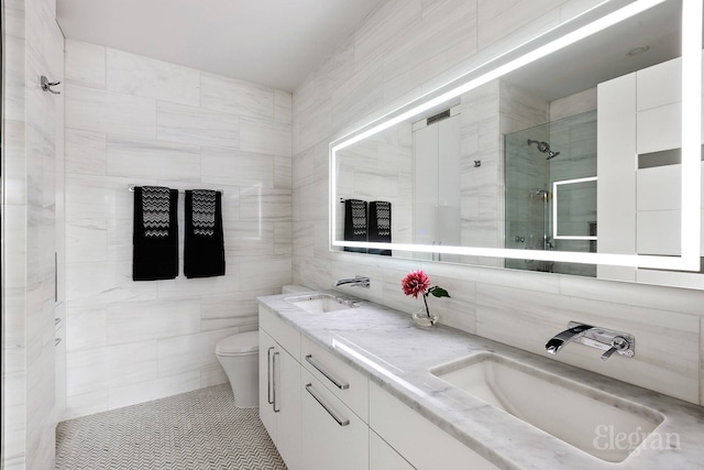 200 E 69th St Unit 28B, New York City, NY 10021 - bathroom featuring a shower stall, tile walls, double vanity, and toilet