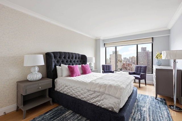 200 E 69th St Unit 28B, New York City, NY 10021 - bedroom featuring light wood-style floors, ornamental molding, wallpapered walls, a view of city, and baseboards