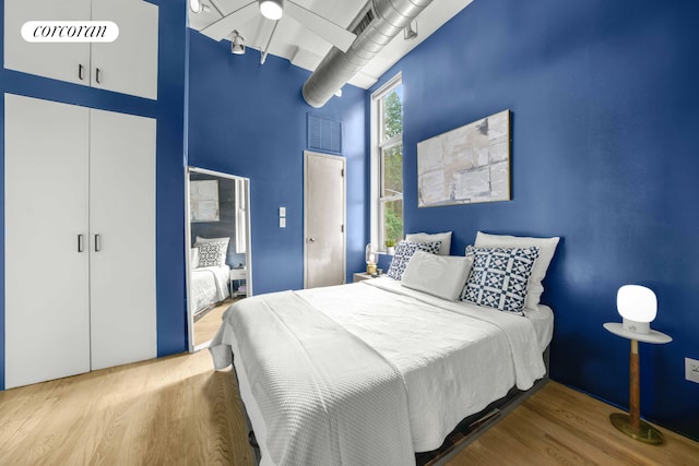 176 Johnson St Unit 2E, New York City, NY 11201 - bedroom with a towering ceiling, wood finished floors, and a closet