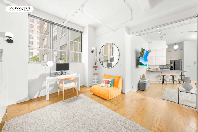 176 Johnson St Unit 2E, New York City, NY 11201 - living area featuring rail lighting, a desk, and light wood-style floors