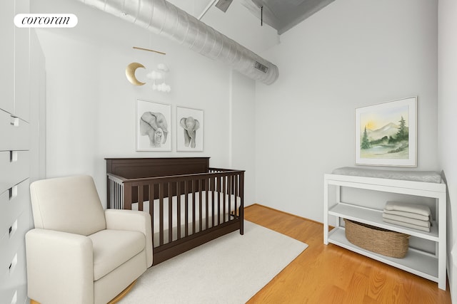 176 Johnson St Unit 2E, New York City, NY 11201 - bedroom with a nursery area and wood finished floors