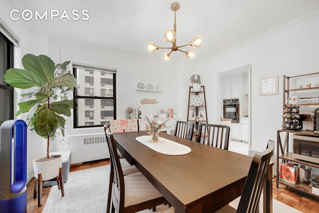 301 E 48th St Unit 5D, New York City, NY 10017 - dining room with ornamental molding, radiator, and a chandelier
