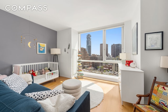 200 Chambers St Unit 25F, New York City, NY 10007 - bedroom featuring light wood-style flooring and a skyline view